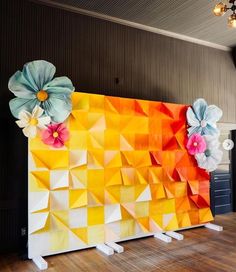 this is an image of a wall made out of paper and some flowers on it