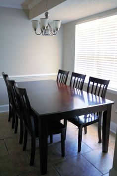 a dining room table with six chairs and a chandelier