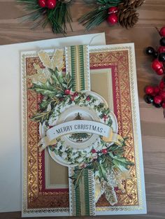 a christmas card with holly wreaths on it and pine cones in the background, next to some red berries