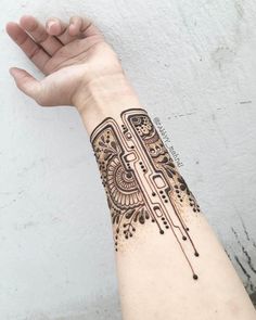 a woman's arm with a tattoo on it and an intricate design in the middle