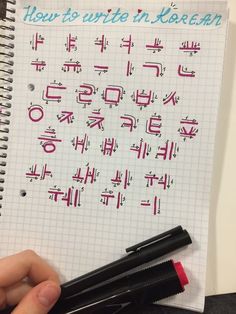 a hand holding a pen over a notebook with writing on it and the words how to write in korean