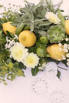 an image of a table with flowers and lemons