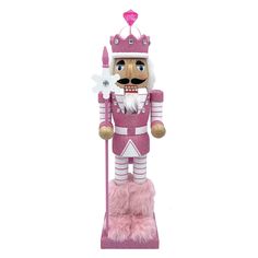 a pink and white nutcracker with a heart on it's head, holding a stick