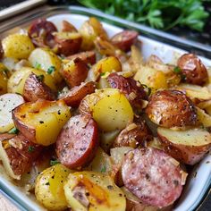 a dish with potatoes, sausage and parsley