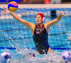 a woman is playing water polo in the pool