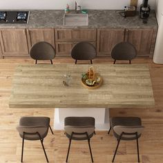 an overhead view of a kitchen table with four chairs