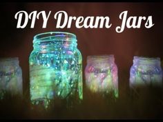 four mason jars with colorful lights in them