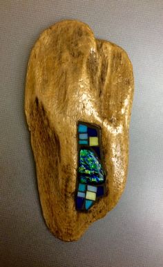 a piece of art that looks like a rock with a glass bead in it