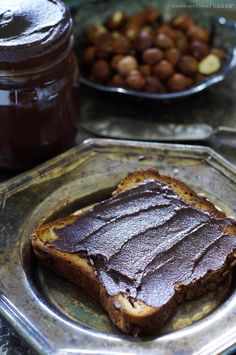 two plates with food on them, one has peanut butter and the other has jelly