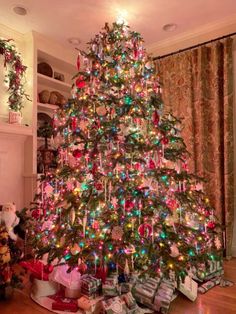 a brightly lit christmas tree in a living room