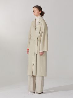 Editor's NotesThis oversized fit raglan sleeve coat made from cashmere wool blend has elegant loose silhouette expressing chic sophisticated mood. The belt helps creating different silhouettes with slender waist line.- Woolmark certified cashmere wool blend- Subtle shine and soft texture- Double layered fabric- Curved shoulder line- Self fabric belt- Reversible design- Side pockets on one side and patch pockets on the other- Notched collarMeasurements(in.)36(S) / 38(M)- Chest: 21.73 in. / 22.76 in.- Neck to Sleeve Length: 28.94 in. / 29.69 in. - Total Length: 45.51 in. / 46.50 in.* Model Info: Height 5' 9.5 , Bust 31.10 in., Waist 22.83 in., Hip 35.04 in. / Fitting size MComposition & Care- 30% Cashmere, 70% Wool- Dry cleaning onlyDesigner- by MUSEE Beige Long Sleeve Cashmere Wool Coat, Raglan Sleeve Coat, Cream Wool Double-breasted Outerwear, Beige Single-breasted Wool Coat, Soft Knit Cashmere Long-sleeve Outerwear, Single-breasted Long Sleeve Cashmere Outerwear, Layered Fabric, Fabric Belt, Cashmere Wool