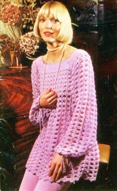 a woman wearing a pink crochet sweater and leggings