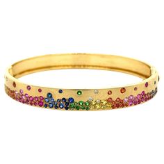 18K Yellow Gold Bracelet with Multi-Color Gemstones and Diamonds 23 Blue Sapphires - 0.48 CT 5 Diamonds - 0.06 CT 8 Green Garnets - 0.16 CT 18 Orange Sapphires - 0.40 CT 33 Pink Sapphires - 0.76 CT 13 Yellow Sapphires - 0.32 CT 18K Yellow Gold - 18.64GM SIZE - 48X58 MM Experience the mesmerizing beauty of our exquisite 18K gold bracelet, adorned with a stunning array of unique, intricately cut gemstones. Each piece features a captivating combination of vibrant multi-color sapphires, green garnet 18k Gold Bracelet, Mesmerizing Beauty, Green Garnet, Orange Sapphire, Yellow Gold Bracelet, Yellow Sapphire, Sparkle Diamonds, Pink Sapphire, Blue Sapphire