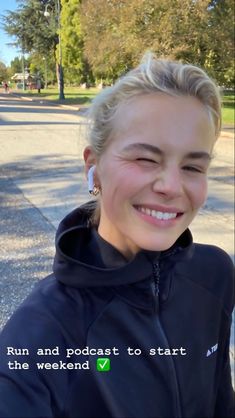 a woman with blonde hair smiling and wearing a black hoodie that says run and podcast to start the weekend