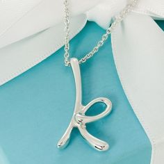 100% Authentic Tiffany Silver Letter K Necklace 18" 1.5mm Chain. Pendant Measures 1.3" Long. 6.1 Total Grams. Teal Box & Ribbon Included. Letter Pendant Necklace Tiffany & Co., K Alphabet, Letter K Necklace, K Necklace, Box Ribbon, Elsa Peretti, Letter K, Initial Pendant, Chain Pendant