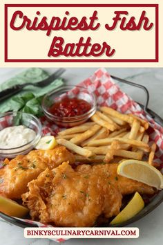 fish and fries are served on a plate with ketchup, lemon wedges and mayonnaise