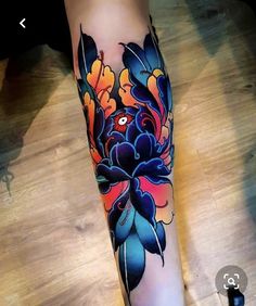 a woman's leg with colorful flowers on it