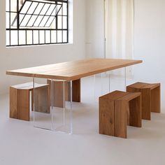 a wooden table and benches in front of a window