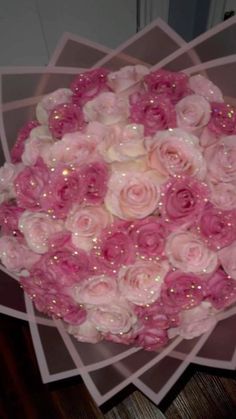 a bouquet of pink and white roses on top of each other