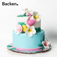 there is a blue and white cake with pink flamingos on the top it says backen