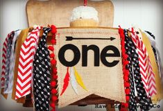 a chair with a one sign on it and some red, white and blue streamers