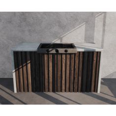 an outdoor bbq with grill and sink on concrete ground