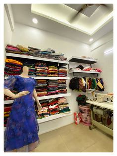 a woman's clothing store with mannequins and dresses