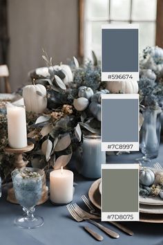 the table is set with blue and white dishes, silverware, candles, and pumpkins