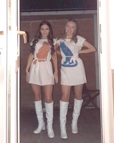 two women in short dresses and white boots are posing for the camera with their hands on their hipss