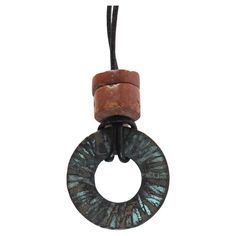 Circa 1990's hammered patinated bronze circle with bauxite bead accent. On thin round black leather cord, pendent is 1.25" diameter, bead is .5" diameter, cord is 28", overall oxidation. Suspension Vintage, Circle Pendant, Leather Cord, Artist Studio, Jewelry Collection, Jewelry Design, Black Leather, Collectibles, Pendant