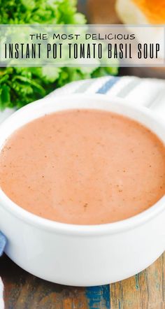 the most delicious instant potato basil soup in a white bowl on top of a wooden table