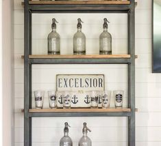 a shelf with bottles and glasses on it