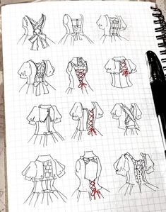 a notebook with sketches of different types of clothing on it and a pen resting next to it