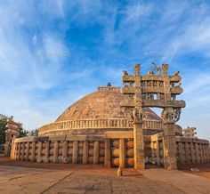 an old stone structure with statues on top in the desert - stock photo - images