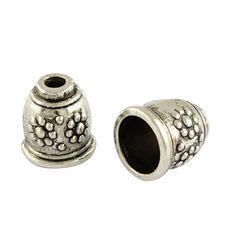 two silver beaded spacers on white background