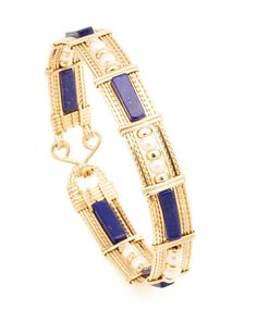 Beautiful wire wrapped bangle of 14k gold-filled wire with Lapis Lazuli Gemstone beads. Select from 2 different styles Lapis1 - Long Square Tube with Pearls & Gold beads (BR_LLSTPGB_01) $129 Lapis2 - Double Rectangle with Gold beads (BR_LDRGB_02) $149