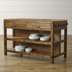 a wooden table with plates and bowls on it