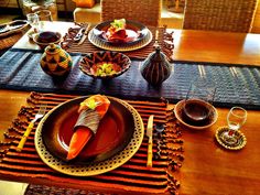 the table is set with plates, cups and utensils