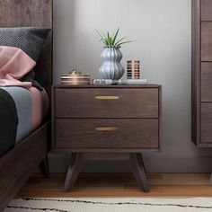 a bedroom scene with focus on the nightstand and bed