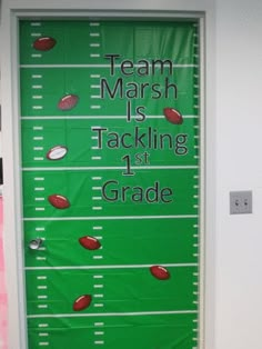 a door decorated with footballs and the words team marsh is tacking 1st grade