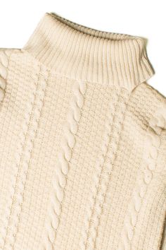 a white sweater is shown with buttons on the collar and sleeves, as if it were knitted from wool