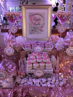 a table filled with pink and white desserts