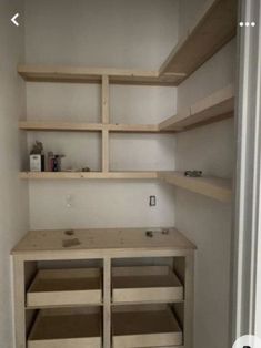 an empty closet with shelves and drawers