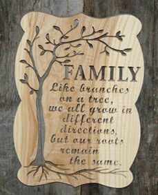 a wooden plaque with the words family on it and a tree in the center that reads,