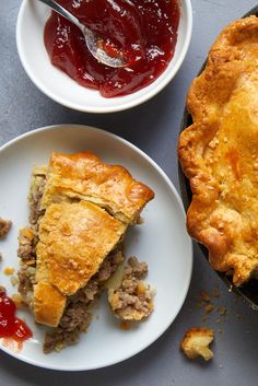 there are two plates with pies on them and one has sauce in the bowl