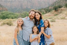 a family posing for a photo in the mountains