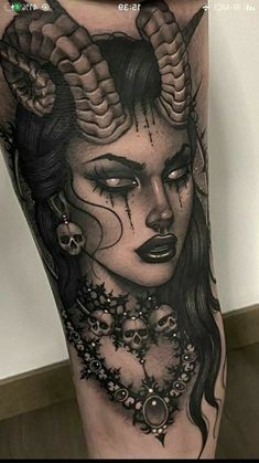 a woman with horns and skulls on her leg is shown in black and grey ink