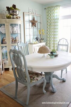 a table and chairs in a room with blue walls