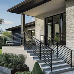 a modern house with white brick and black railing