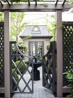 an open gate leading to a small house